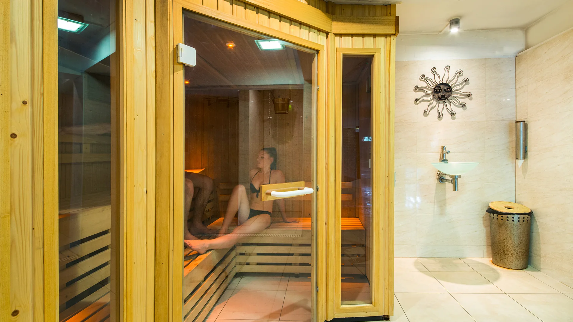 A couple relaxing in the sauna.