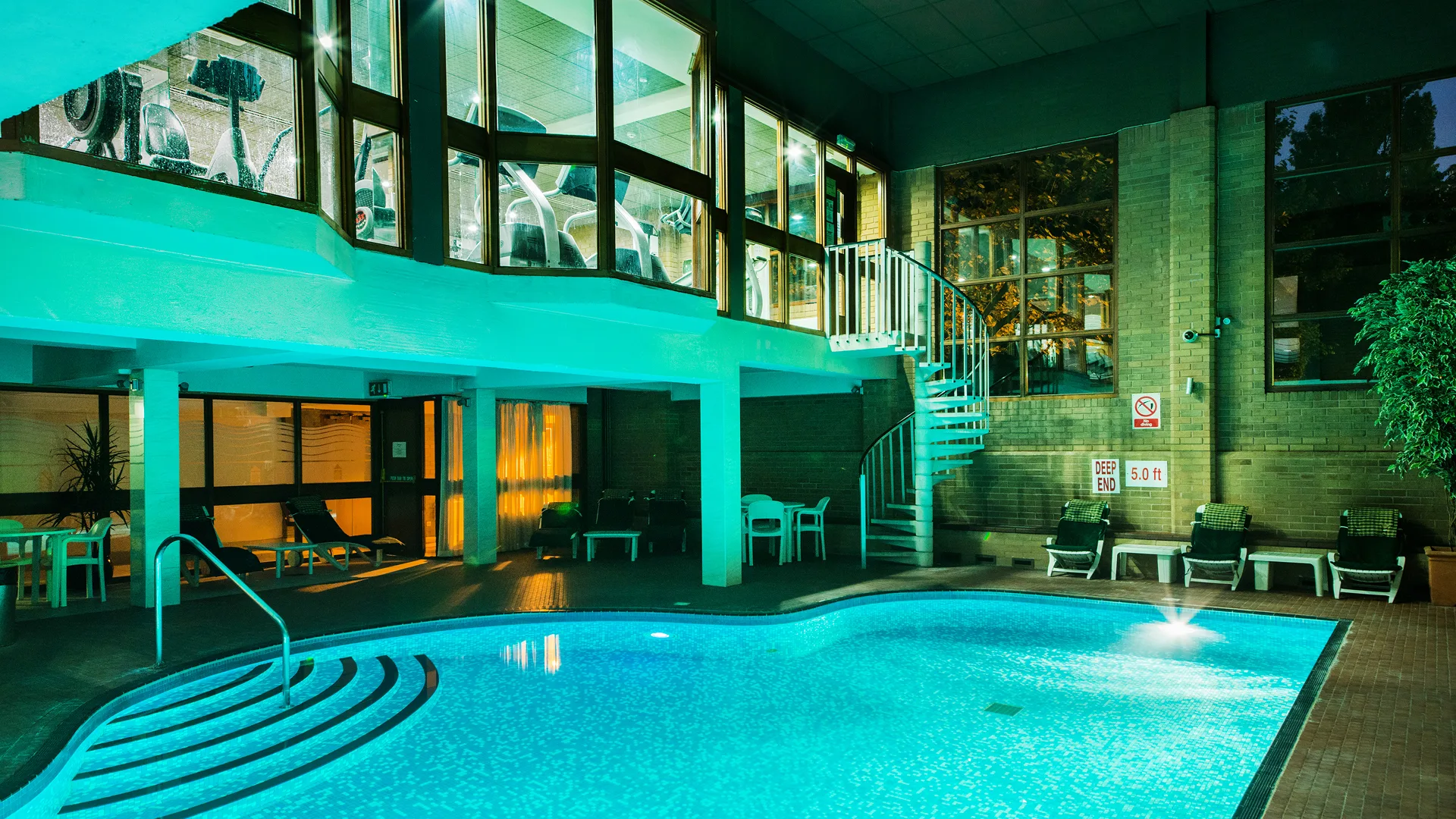 The illuminated heated pool of The Arden Hotel & Leisure Club.