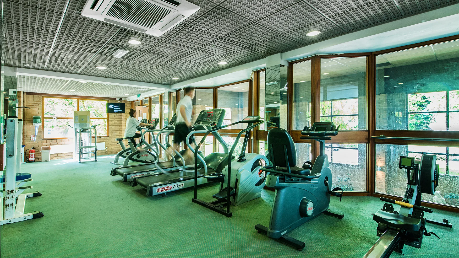 Guests running on a treadmill in the gym.