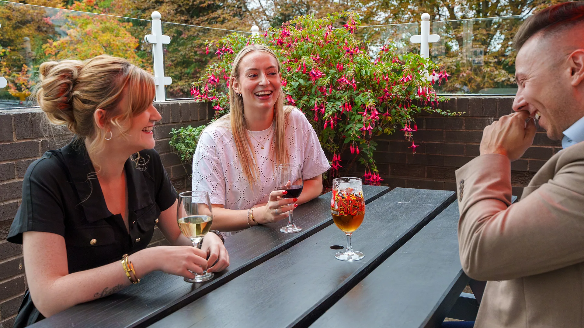 Chatting in the outside dining area with drinks. 
