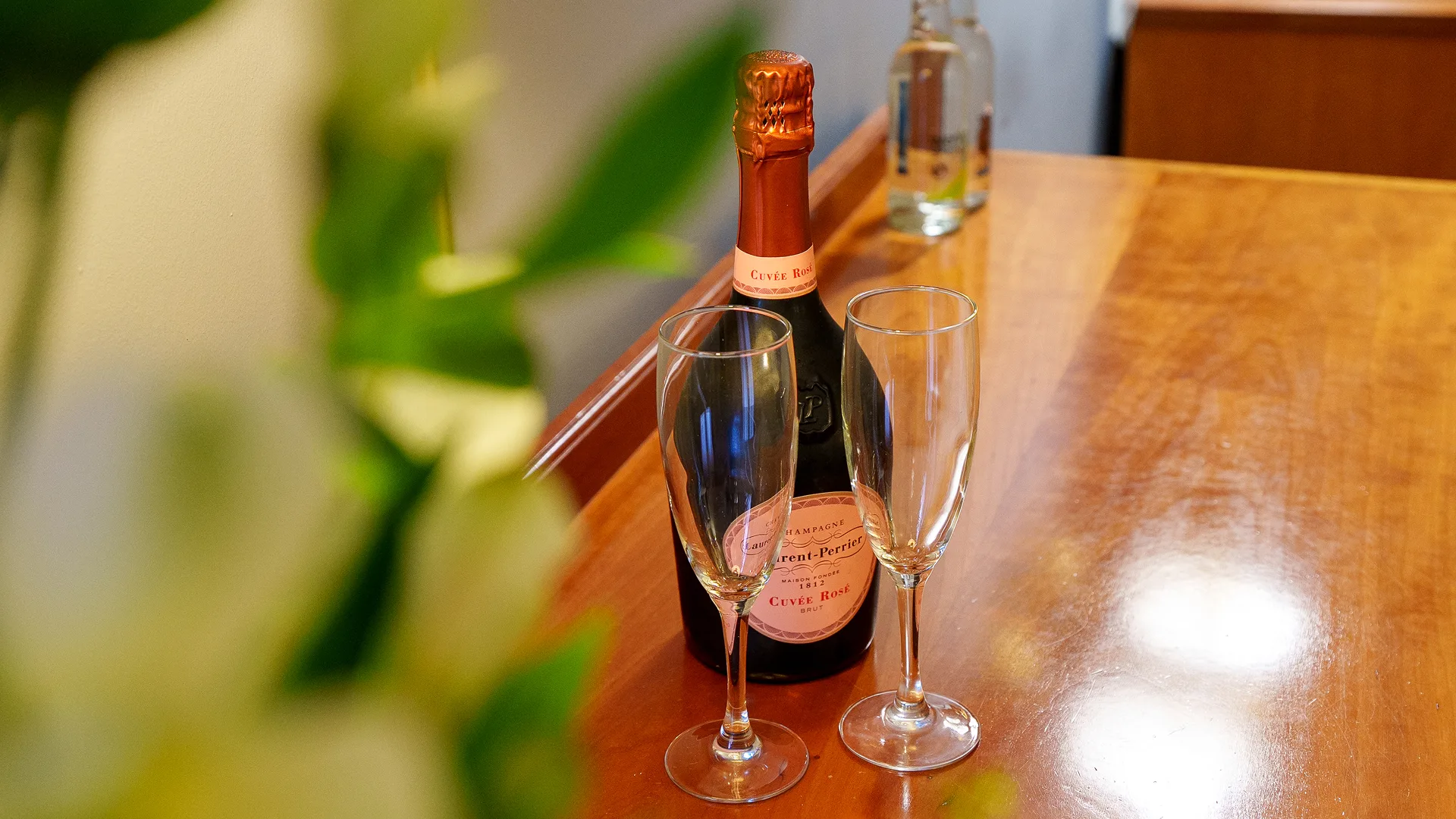 A bottle of sparkling rosé and two waiting glasses, ready to raise a toast.